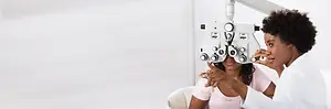 Woman at eye clinic with doctor checking her vision