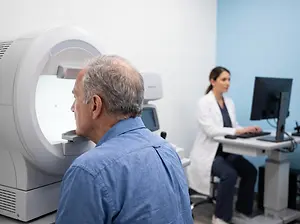 man having his eyes checked in a clinic