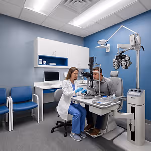 Eye doctor using specialized equipment to examine a patient's eyes