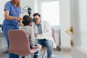An optometrist performing a pediatric eye exam at Las Vegas Eye Exam at Las Vegas, NV.