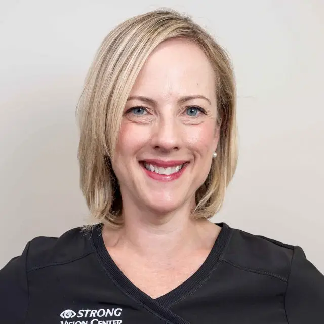 Strong Vision Center employee wearing black shirt with white text on it.