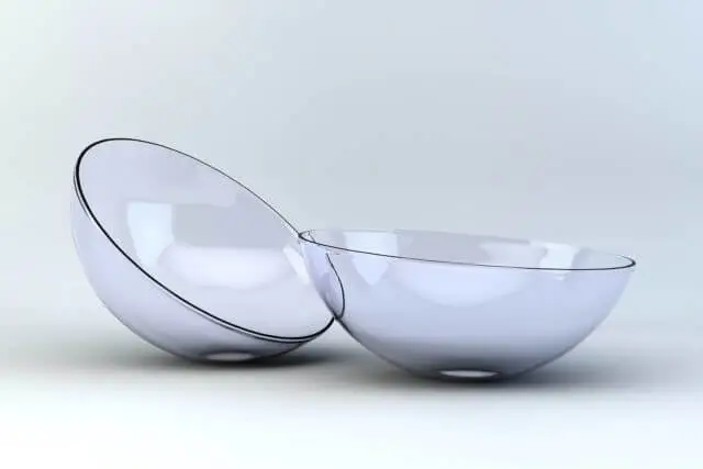 Two transparent glass bowls sitting next to each other on a white surface