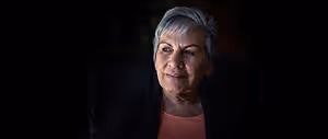 Portrait of an older woman with gray hair smiling for the camera