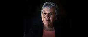 Portrait of an older woman with gray hair smiling for the camera
