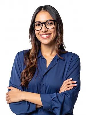 A woman with glasses is smiling and posing for a photo with her arms crossed