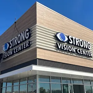 A storefront with the sign that reads Strong Vision Center