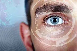 Close-up of a man's eye with a futuristic circular pattern overlaying it