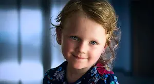 Close up portrait of a girl with blue eyes smiling