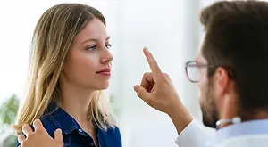 A doctor is explaining something to a woman in an office.
