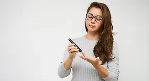 woman checking her blood sugar level