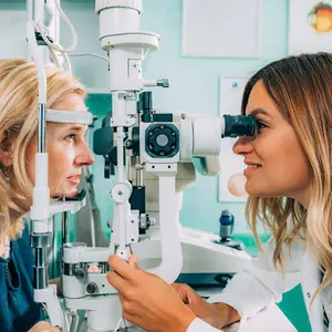 woman getting her eyes checked by another woman