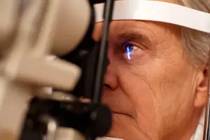 A man is having his eyes examined by an optometrist