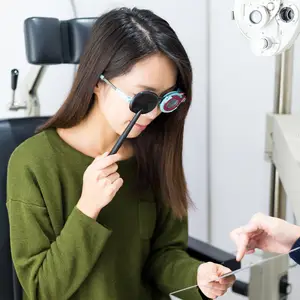 A woman getting her eyes examined by an optometrist