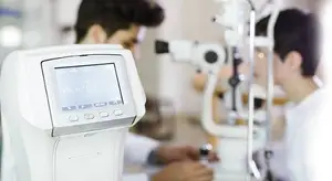 A man is checking his eyesight using a machine in an optical clinic