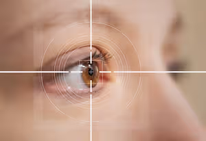 An eye with a cross-hair focus on the pupil