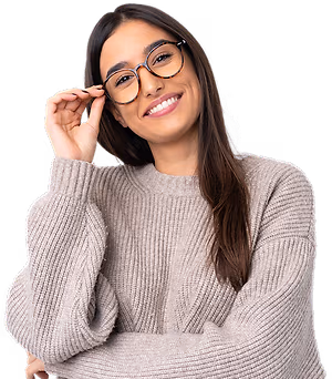 A woman wearing glasses and a gray sweater is smiling and posing for a picture.