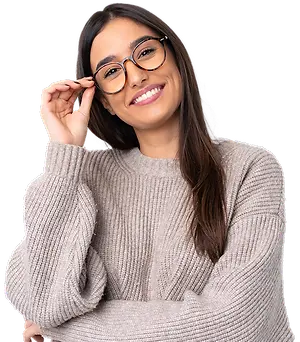 A woman wearing glasses and a gray sweater is smiling and posing for a picture.