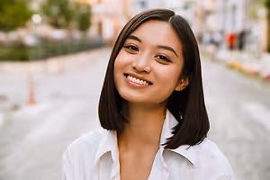 Woman smiling in front of a city street