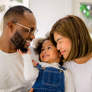 A happy family with a young child smiling