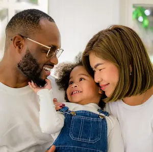 A happy family with a young child smiling