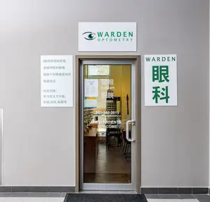 The entrance of Warden Optometry in Markham, ON, with multiple signs in Chinese and English and a welcome message for new patients.