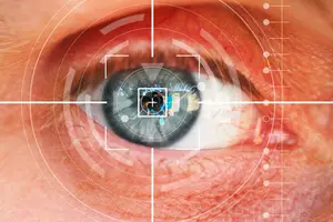 Close-up of an eye with a laser grid overlay for biometric security, showing iris detail and reflections