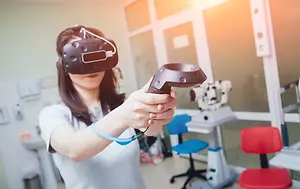 A woman using a virtual reality headset in a medical room