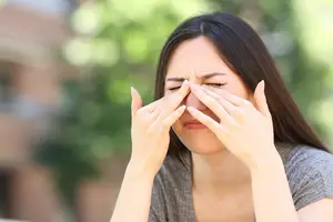 Woman covering her eyes with her hands