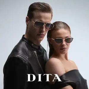 Man and woman wearing sunglasses pose for a photo with the word DITA in white text