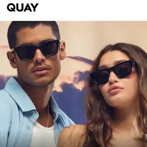 Man and woman wearing sunglasses standing close together