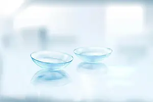 Two clear glass bowls on a white surface with a blurry background