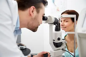 A woman having an eye examination by an optometrist