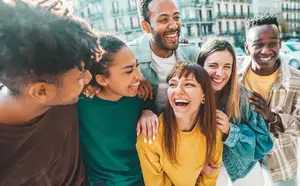 Happy Diverse Group of Friends Laughing Outdoors in City Setting