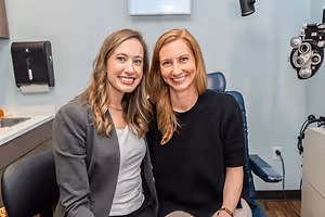 Two women smiling in an optometrist's office