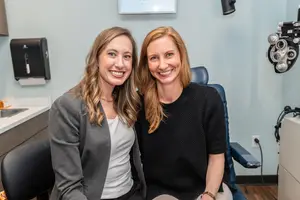 Two women smiling in an optometrist's office