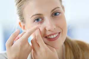 woman wearing a contact lens on her eye