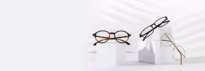 Three pairs of glasses on white boxes