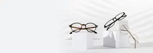 Three pairs of glasses on white boxes