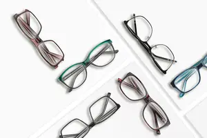 Six pairs of glasses with different colors and frames displayed on a white background