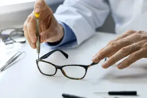 Close up of an optician adjusting a pair of glasses
