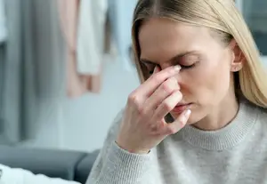 a woman is blowing her nose into a tissue paper