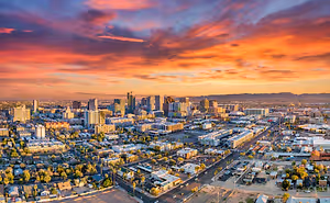 A stunning aerial view of a cityscape with a sunset sky in the background