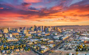 A stunning aerial view of a cityscape with a sunset sky in the background