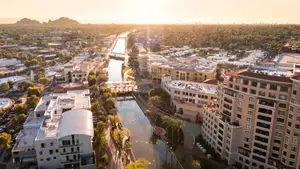 Aerial view of a city with a canal in the center and buildings on both sides.