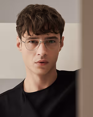 young man wearing glasses looking at something