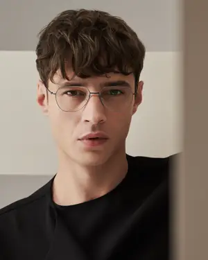 young man wearing glasses looking at something