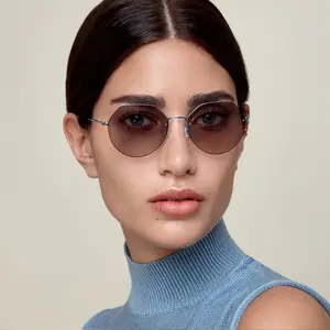 woman wearing blue turtleneck top and sunglasses