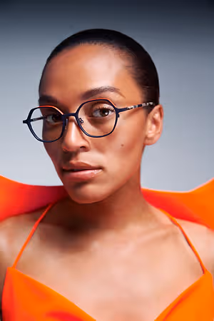 woman wearing eyeglasses and orange top