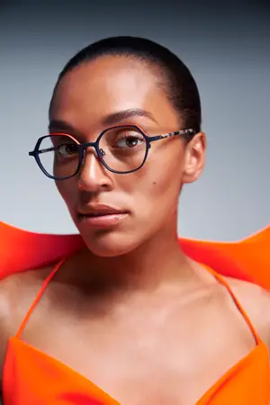 woman wearing eyeglasses and orange top