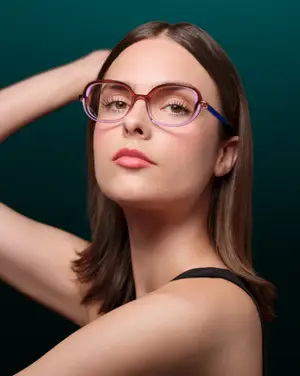 Portrait of a woman with glasses and wearing a black sleeveless top